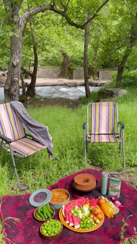 Scenic River Picnic Setup with Chairs and Food Video stock 340871642