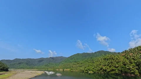 Scenic River Surrounded by Mountains and Trees with Small Boats Stock Footage 336691907