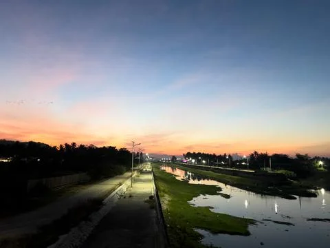 Scenic Riverside Path at Sunset Stock Photos