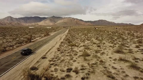 Scenic Road Trip Through Death Valley, Aerial Drone View of Black SUV Stock Footage 238019366