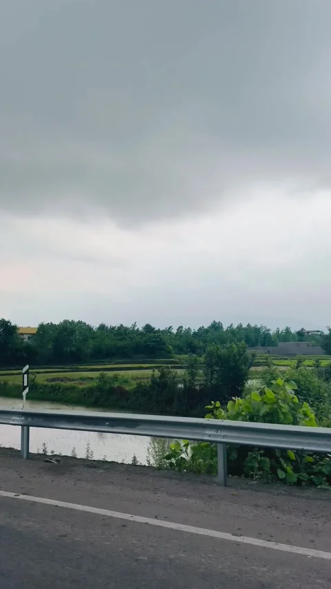 Scenic road trip view under a cloudy sky, POV from inside a moving car Vídeos de archivo 336848994