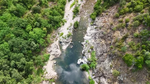 Scenic Rocky River Flowing Through the Lush Landscape of Anduze, France Stock-Footage 340347028