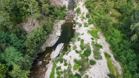Scenic Rocky River Flowing Through the Lush Landscape of Anduze, France Stock Footage 340347339