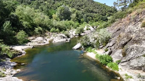 Scenic Rocky River Flowing Through the Lush Landscape of Anduze, France Stock Footage 340347805