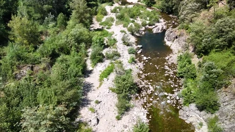 Scenic Rocky River Flowing Through the Lush Landscape of Anduze, France Stock Footage 340348582