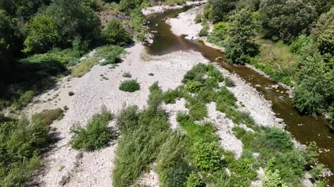 Scenic Rocky River Flowing Through the Lush Landscape of Anduze, France Stock-Footage 340348935