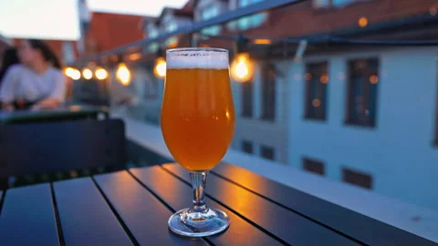 A Scenic Rooftop Beer Glass at Sunset Captured in Stunning 4K Resolution Stock Footage 315073790