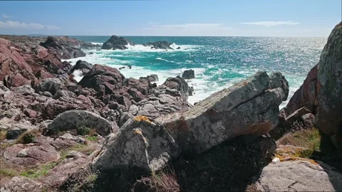 Scenic rugged coastline with ocean waves crashing on rocks in spain Video stock 320304007