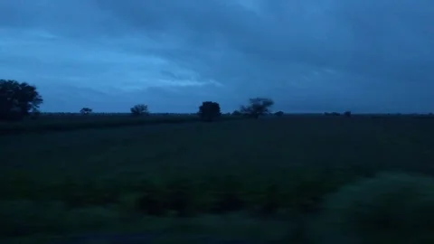 Scenic rural landscape with dramatic dark clouds over green fields, capture.. Stock Footage 341352404
