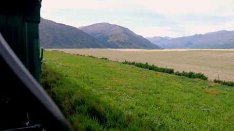Scenic rural landscape with green fields mountains viewed from historic train 스톡 동영상 342004286