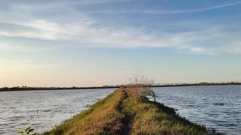 Scenic Rural Path Between Water Reservoirs at Sunset Video stock 341506624