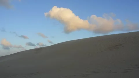 Scenic sand dune landscape with clouds moving in blue sky Video stock 338092920