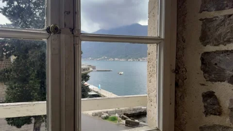 Scenic sea view through open window with traditional red roof houses in Mediterr Stock Footage 332403645