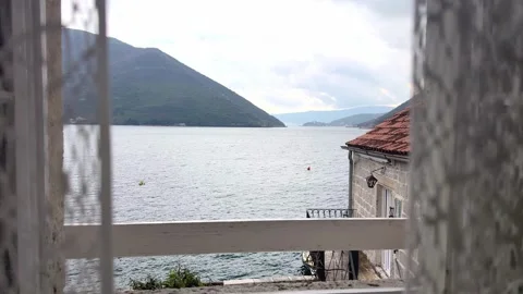 Scenic sea view through open window with traditional red roof houses in Mediterr Stock Footage 332404044