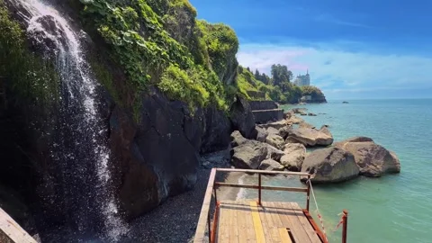 Scenic seaside cliff with a waterfall and rocky coast in Batumi, Georgia Vidéo 345834294