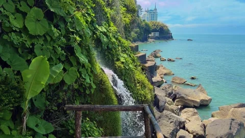 Scenic seaside cliff with a waterfall and rocky coast in Batumi, Georgia Stock Footage 345834476