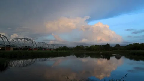 Scenic sky,billowing,ever-changing clouds fly across wide lake. Stock Footage 260238852