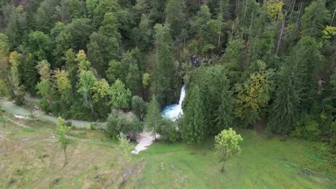 Scenic small waterfall in forest farm river and bike trail in bohinj slovenia Stock Footage 307454496