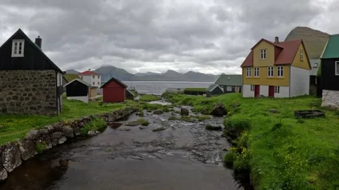Scenic stream flowing through the traditional village of Gjogv, Faroe Islands Stock Footage 340009030