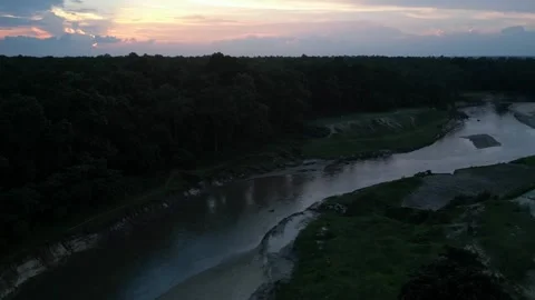Scenic sunset aerial view over winding river and dense forest landscape Stock Footage 341978294