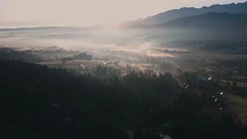 Scenic sunset drone flight above mountain range silhouette aerial view. Stock Footage 164035758