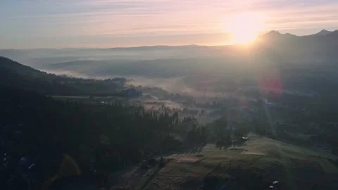 Scenic sunset drone flight above mountain range silhouette aerial view. Stock Footage 164035824