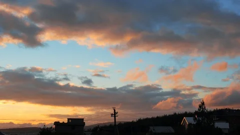 Scenic sunset with fast moving clouds over houses in countryside, beautiful sky Stock Footage 98527070