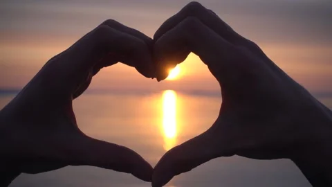 Scenic sunset, hands folded in shape of heart Sign language Lake Baikal ice love Video stock 165217642