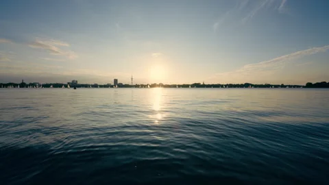 Scenic sunset landscape over water with boats and distant shore Vídeos de archivo 346245212