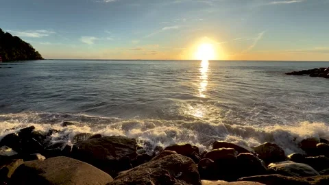 Scenic Sunset Landscape of Sea Waves Crashing on Rocky Beach Stock Footage 345953686