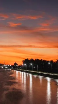 Scenic Sunset Over a Calm River Stock Photos