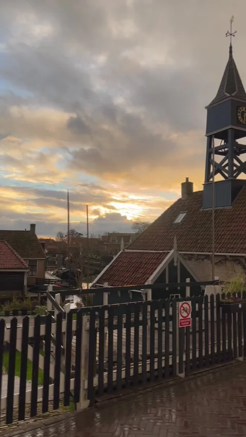Scenic sunset over a historic clock tower and village in the Netherlands. Stock-Footage 340850987