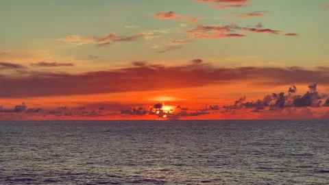 A scenic sunset over the ocean with vibrant orange and pink hues blending i.. Stock Footage 338281843