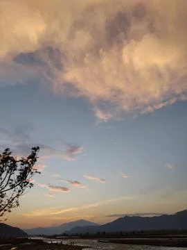 Scenic sunset sky with dramatic clouds and mountain horizon Stock Photos