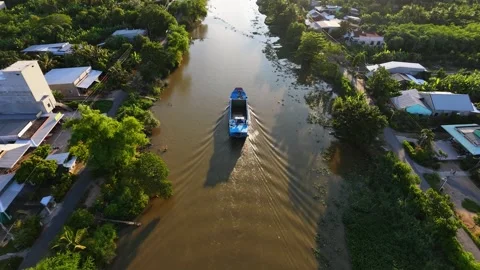 Scenic Sunset View Of Boat Navigating River Surrounded By Green Banks Stock Footage 340548137