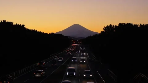 Scenic sunset view of Mount Fuji and coastal road in Chigasaki. 4K Slow Motion. Stock Footage 328627976