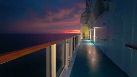 Scenic sunset view from a ship's deck with vibrant colors and ocean horizon Stock Footage 317325361