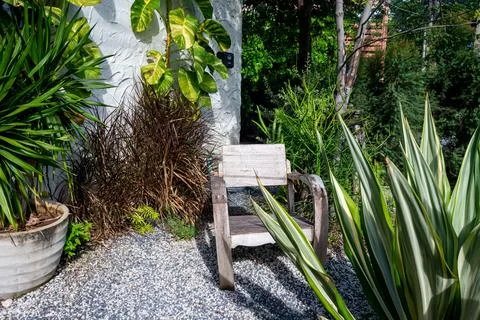 Scenic of timber armchair in the garden. Stock Photos