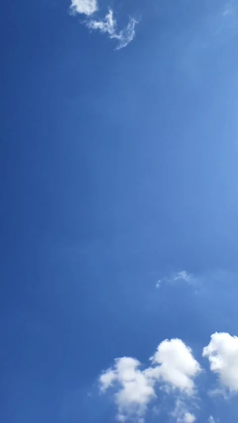 Scenic timelapse video of fluffy white cumulus clouds moving fast across Stock Footage 343202495