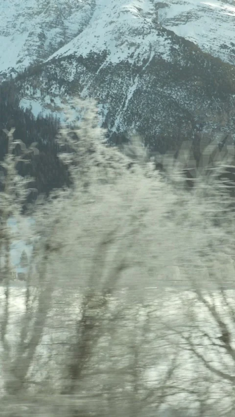 Scenic train ride through snow covered mountain landscape 스톡 동영상 329667729