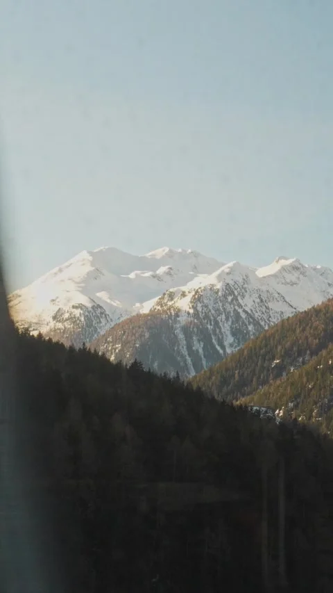 Scenic train ride viewing snowy mountain peaks Stock Footage 329667846