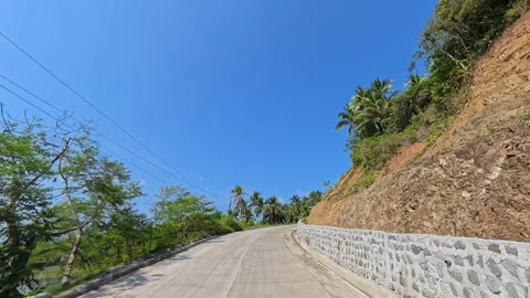 Scenic uphill mountain road with dramatic cliffside view Stock Footage 339267772