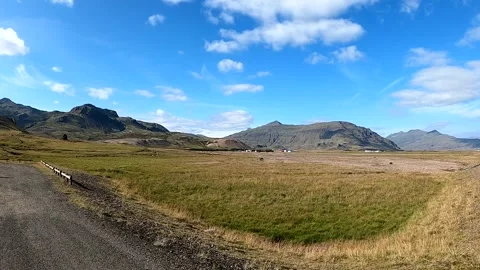 Scenic valley with remote farm at the base of mountains, Iceland Stock Footage 333923362