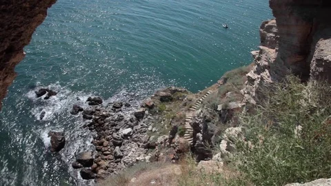Scenic vertical cliffs down to the Black Sea with old stone stairway Stock Footage 70572824