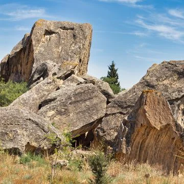 Scenic view of ancient rock formations in Qobustan Rock Art Cultural Landscape Stock Photos