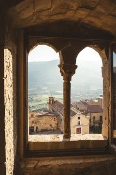 Scenic view from arched stone window in Sperlinga, Sicily at golden hour Stock Photos