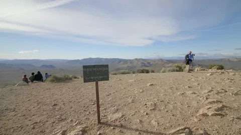 Scenic view atop Ryan Mountain with photographer and hikers enjoying the desert Stock Footage 109481429