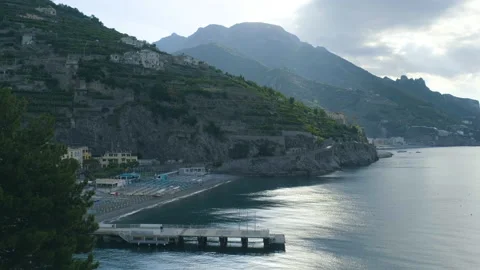 Scenic view of beach with ferry dock in the foreground and mountains in the back Stock Footage 169474920