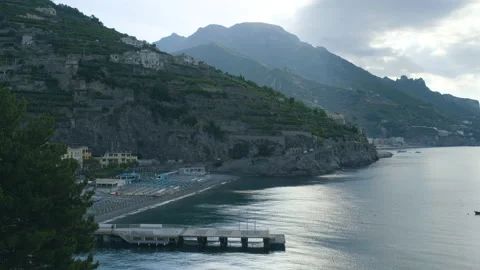 Scenic view of beach with ferry dock in the foreground and mountains in the back Stock Footage 169475236