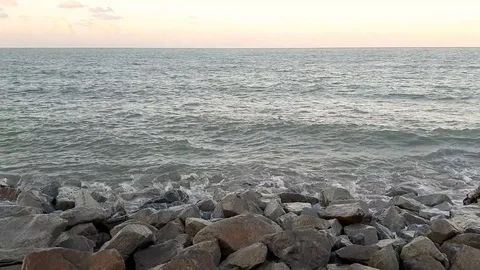 Scenic view of a beach waves hitting rocks Stock Footage 102608805